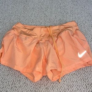 Nike orange Dri-Fit athletic shorts